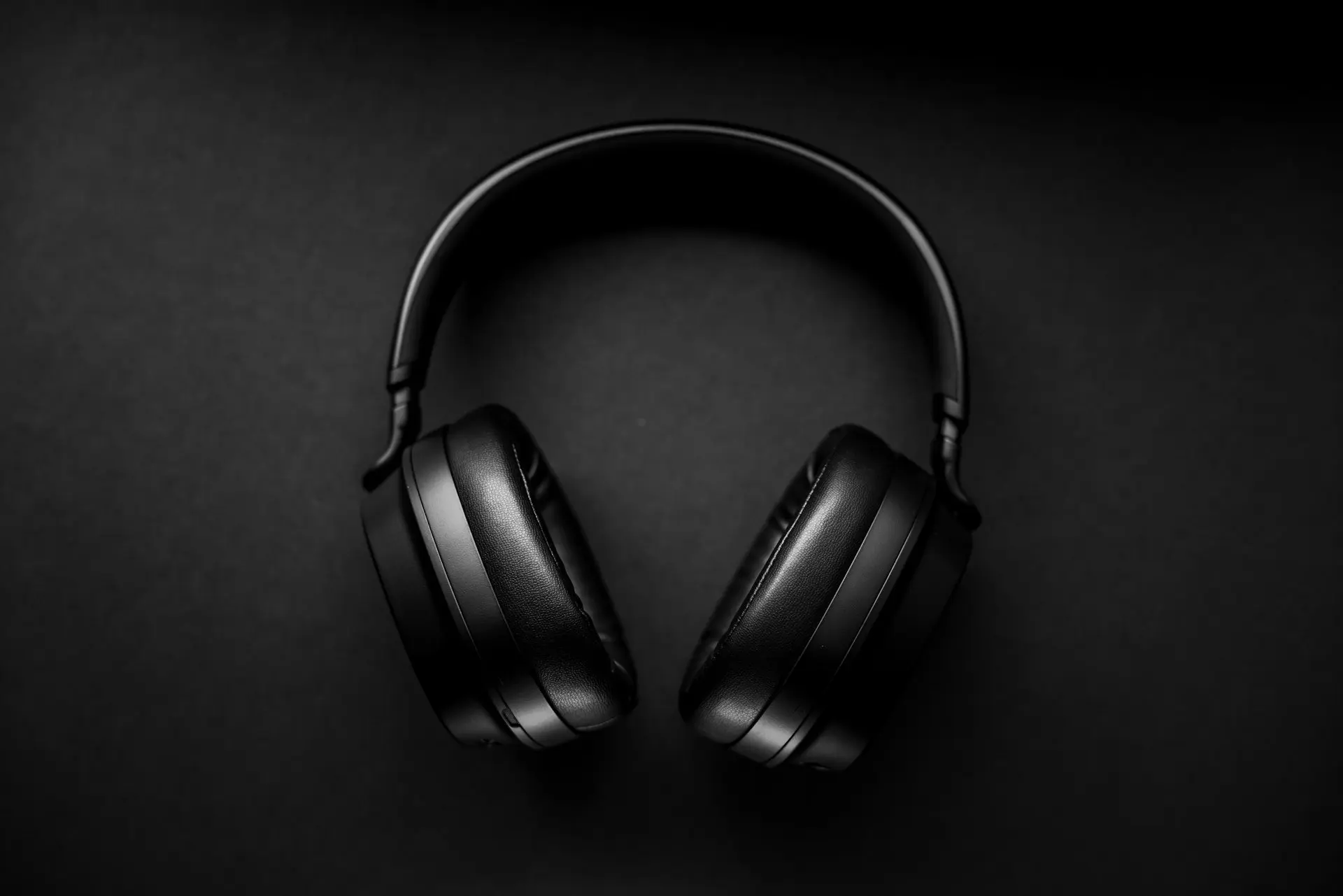 black wireless headphones on black surface